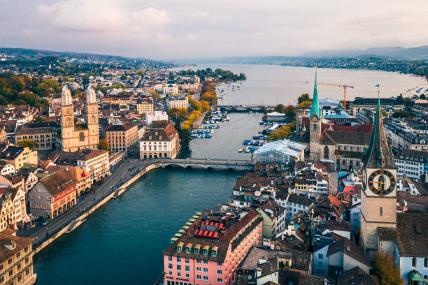Zurich aerial view Aerial view of Zurich, Switzerland. Taken from a drone overlooking the Limmat River. Beautiful blue sky with dramatic cloudscape over the city. Visible are many traditional Swiss houses, bridges and churches. zurich photos stock pictures, royalty-free photos & images