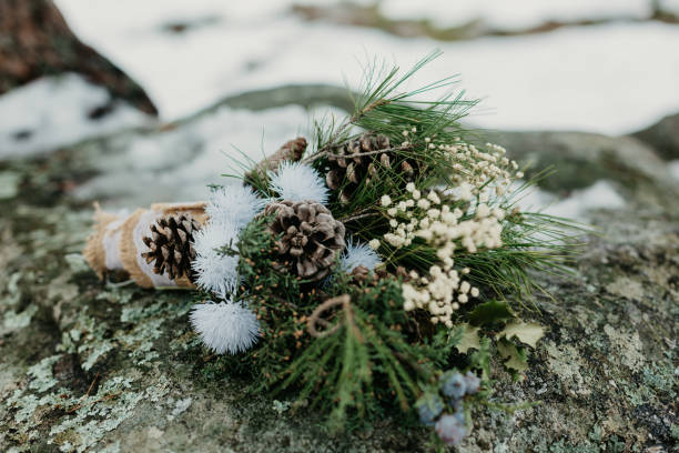 a winter and rustic wedding bouquet on a rock