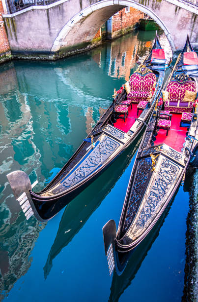 typical gondolas in venice - italy typical famous gondolas in venice - italy gondola traditional boat photos stock pictures, royalty-free photos & images