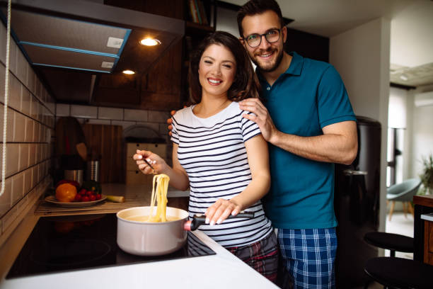 istock Young couple cooking together at home 1150479190