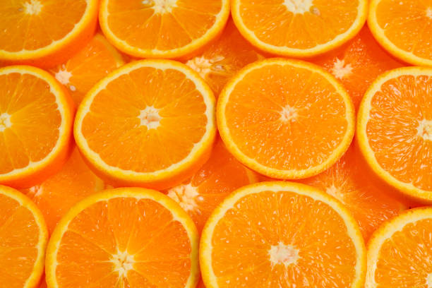 istock Slices of oranges as a background, top view. 1150480179