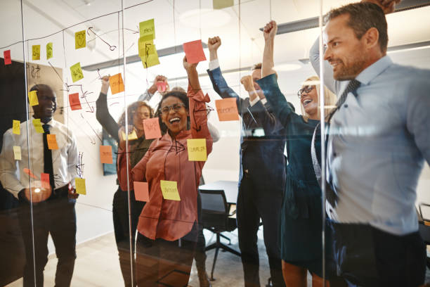 istock Excited businesspeople cheering together after an office brainstorming session 1150482831