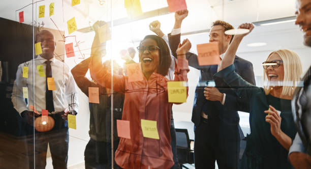 istock Ecstatic businesspeople celebrating success after an office brainstorming session 1150483002