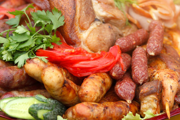 istock Served meat plate with grilled sausages and vegetables sliced 1150483540