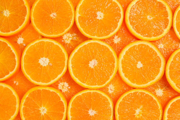 istock Slices of oranges as a background, top view. 1150484382