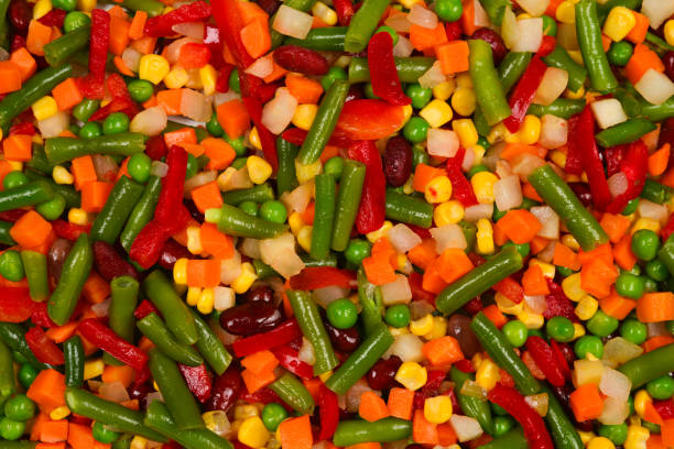 istock Sliced vegetables, corn, beans, peas, carrots, sweet peppers background. 1150484433