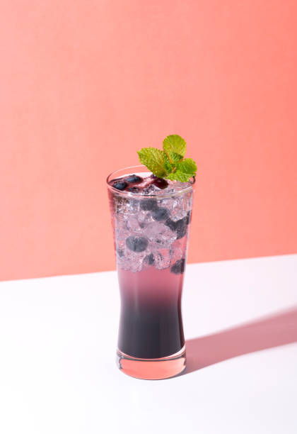 istock Cold and refreshing  blueberry punch cocktail with mint on color background. summer drink 1150486154