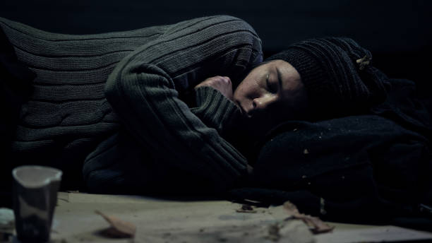 istock Female bum sleeping on dirty street feeling cold, poverty problem, refugee 1150487712