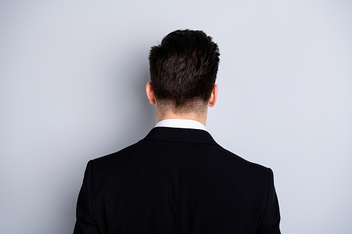 Close up back rear behind view photo of cool smart successful chief stand behind show shoulders feel glad content relaxed wear classic clothes isolated on argent background.
