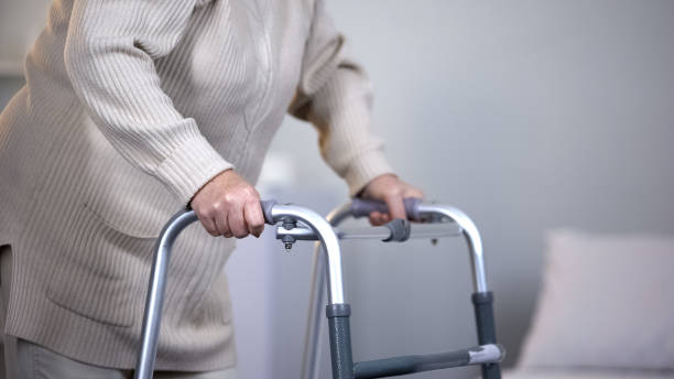 istock Elderly woman using walking frame, rehabilitation after joint trauma, close up 1150489802