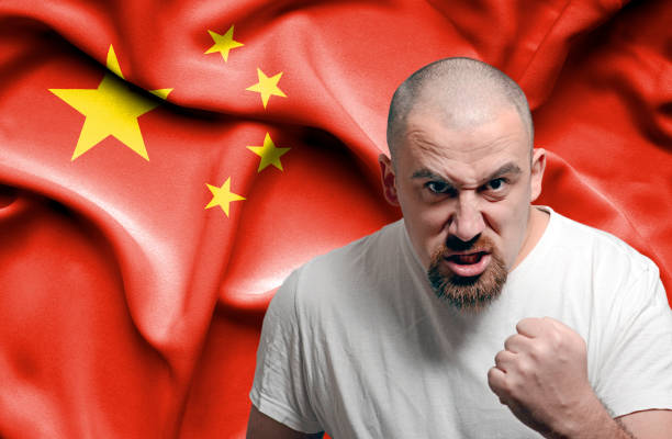 istock Angry man against flag of China 1150490773