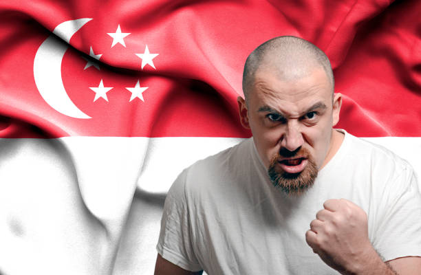 istock Angry man against flag of Singapoore 1150490953