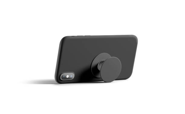 Blank black phone popsocket sticked on cellphone mockup, lying isolated Blank black phone popsocket sticked on cellphone mockup, lying isolated, side view, 3d rendering. Empty dark pop socket round holder opened for smart phone mock up. Clear attached grip on mobile. rubberized stock pictures, royalty-free photos & images