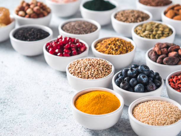 istock Various superfoods in bowl on gray background 1150491957