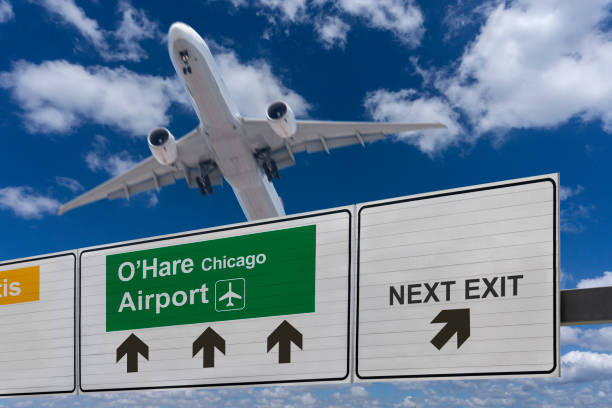 Road sign indicating the direction of O'Hare Chicago airport and a plane that just got up. Road sign indicating the direction of O'Hare Chicago airport and a plane that just got up. landing craft stock pictures, royalty-free photos & images