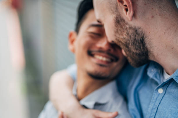 istock Gay couple hugging and flirting 1150493140