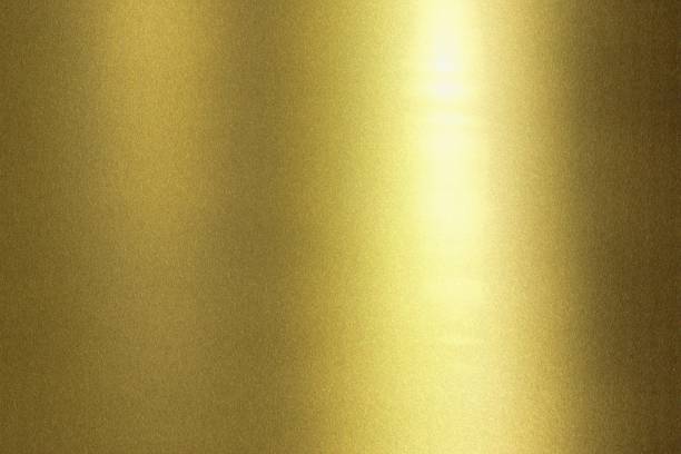istock Light shining on wave golden metal wall, abstract texture background 1150493352