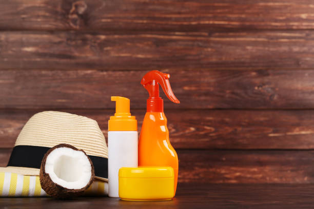 istock Sunscreen bottles with coconut and hat on brown wooden table 1150494087