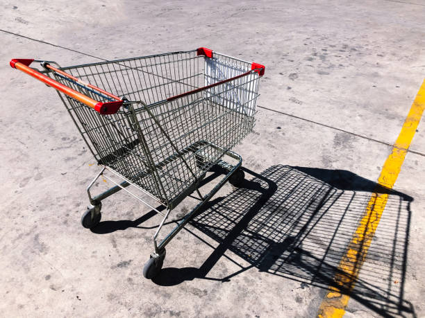 istock Empty Shopping cart in concrete parking under summer sun 1150495553