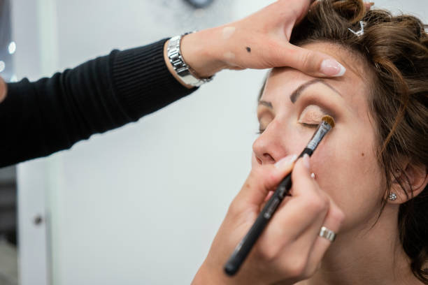 istock Makeup Artist Applying Make Up On Young Woman 1150495713
