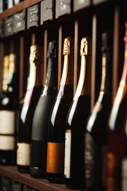 istock Underground cellar with elite sparkling wine on shelves, close up vertical photo. 1150497280