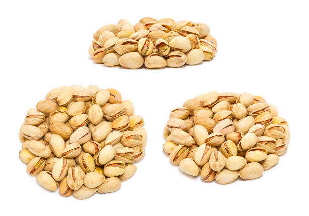 istock Set of handfuls of nuts from different angles - pistachio nuts (Pistacia vera) in the shell 1150498309