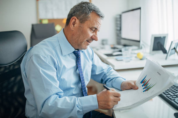 istock Mature businessman works in the office 1150500046