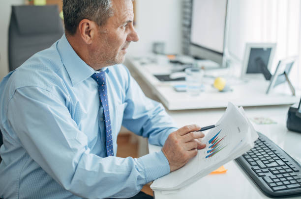 istock Mature businessman works in the office 1150500059