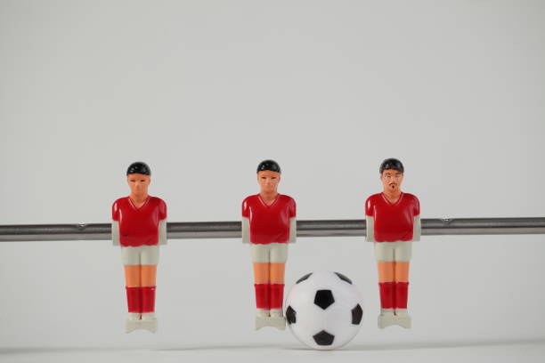 istock Red foosball plastic players. Soccer ball 1150500458
