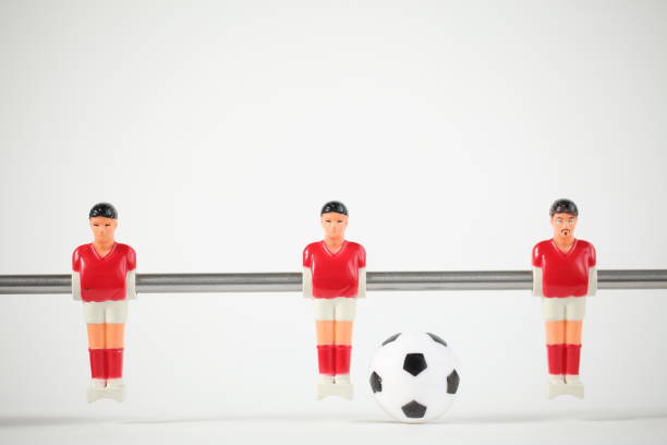 istock Red foosball plastic players. Soccer ball 1150500470