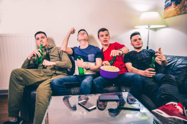 istock Young Group Watching Sport on TV at Home 1150501950
