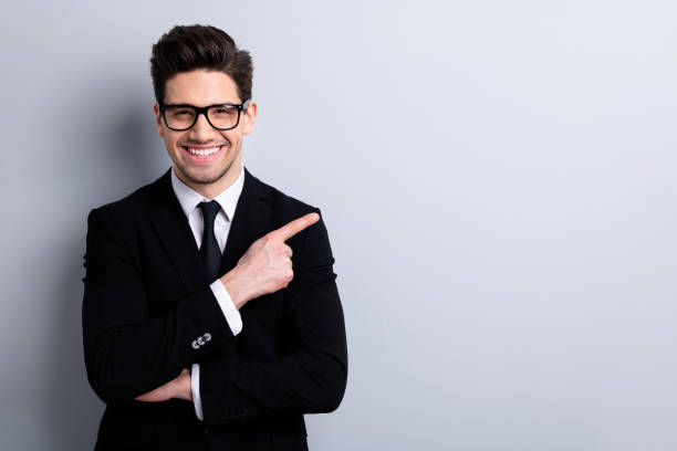 istock Portrait of his he nice imposing representative elegant classy chic attractive cheerful guy sales expert development agent broker pointing aside isolated over light gray background 1150502131