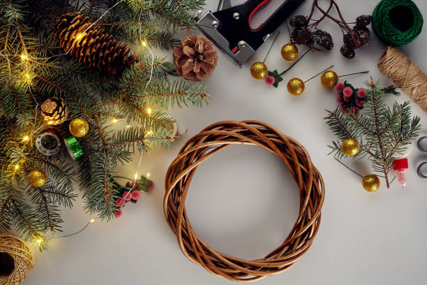 istock Christmas background with decorations, garland and pine cones. Creating wreath made of christmas tree branches on white background. 1150503529