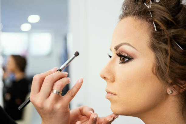 istock Makeup Artist Applying Make Up On Young Woman 1150504554