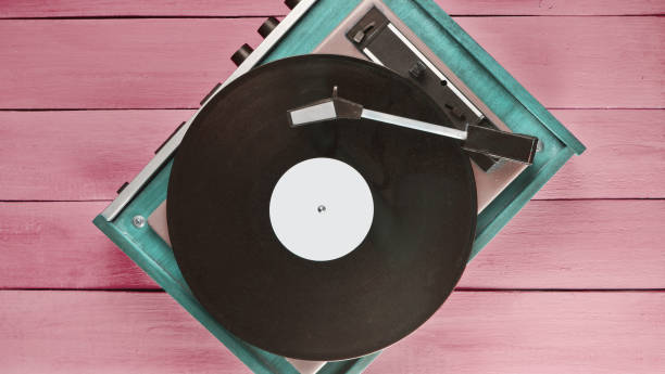 istock Vintage vinyl player on red wooden background. Top view. Retro media technologies 1150506249