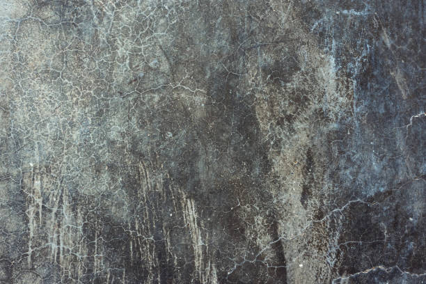 istock Old distressed scratched cement concrete wall background with grungy texture. Gradient black gray colors and shades with blueish tint. Beautiful vintage backdrop template 1150506358