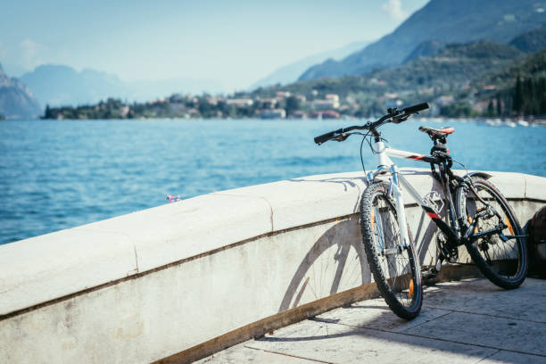 Bike on the foreground, lake garda with blue water in the background