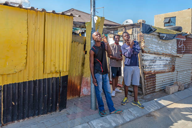 Three african men looking mischievous in Alexandra Township, Johannesburg Three african teenage men looking mischievous in Alexandra Township, Johannesburg. Also known as Alex developed since 1912 and allocated for blacks in the apartheid era, the self governing Alexandra action committee took charge of running Alexandra and now forms part of Johannesburg. alexandra township photos stock pictures, royalty-free photos & images