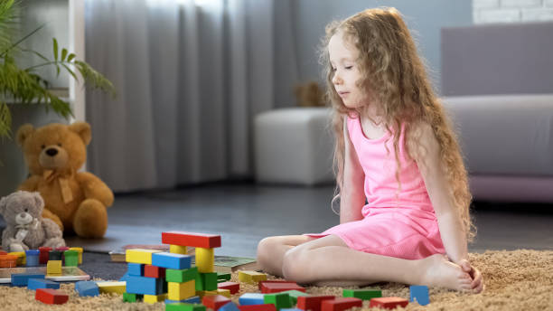 istock Little girl playing with educational toy blocks, early development school 1150510054
