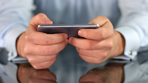 istock Male hands playing game on smartphone, fingers touching screen, gadget addiction 1150511461