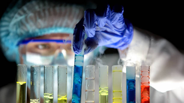istock Chemist analyzing blue liquid reaction in tube, biochemical experiment, drugs 1150511749