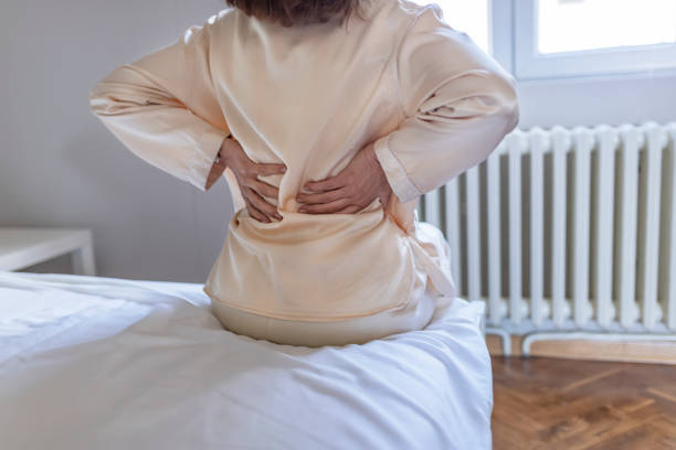 istock Woman feels back pain massaging aching muscles 1150511907
