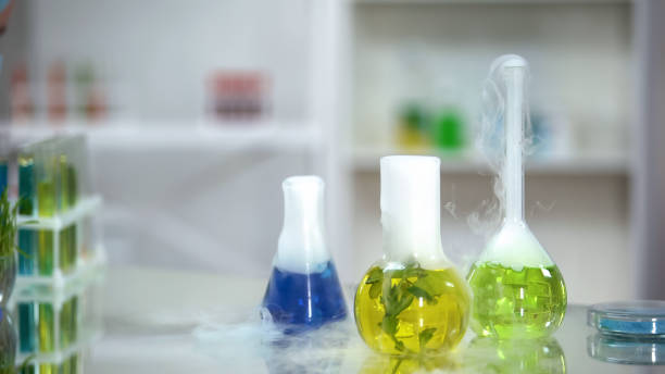 istock Colored organic substances in flask standing on table emitting smoke, extracts 1150512181