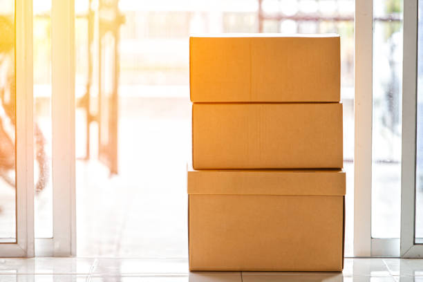 istock Three parcel boxes that are shipped at the front door,Carton box crate 1150512460