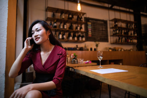 istock Chinese woman making a phone call from cafe 1150513079