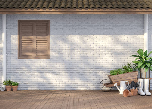 House terrace with garden equipment 3d render House terrace with garden equipment 3d render,There are empty white  brick wall, wood floor and brown roof,Sunlight shining to the wall with tree shadow. building terrace stock pictures, royalty-free photos & images