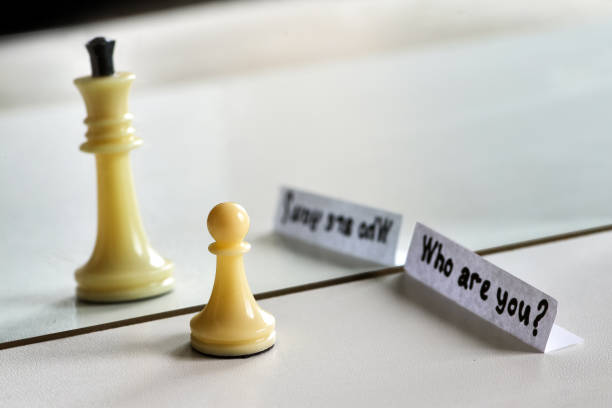 istock Chess in mirror image, concept search opportunities, self-development, improvement, struggle between good and evil,  struggle opposites, search solutions, split personality, human resource management. 1150514748