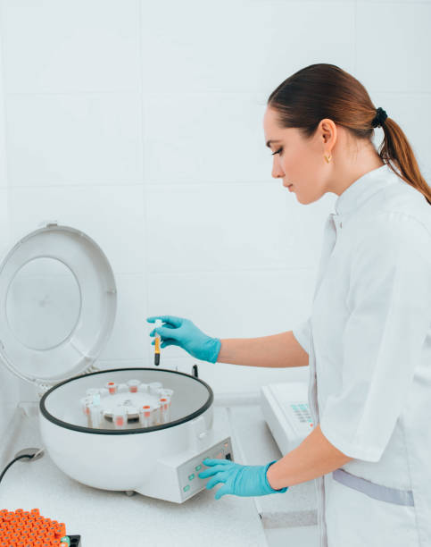 istock Scientist working with blood samples in vials on a centrifuge machine. Blood research 1150514831