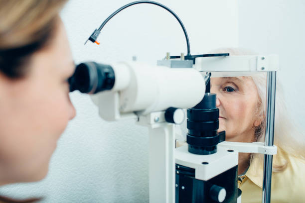 istock Senior woman doing eye test with eye equipment 1150514837