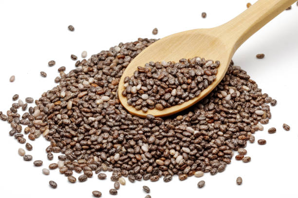 istock Chia seeds in wooden spoon isolated on white 1150517695